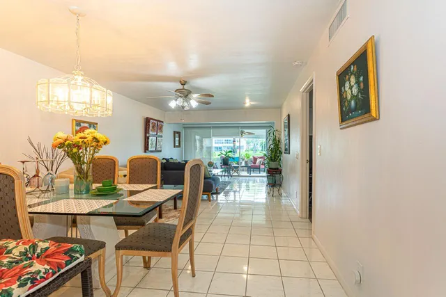 a view of a dining room with furniture and a potted plant