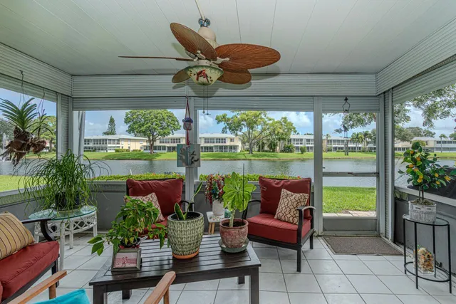 a roof deck with couches and potted plants