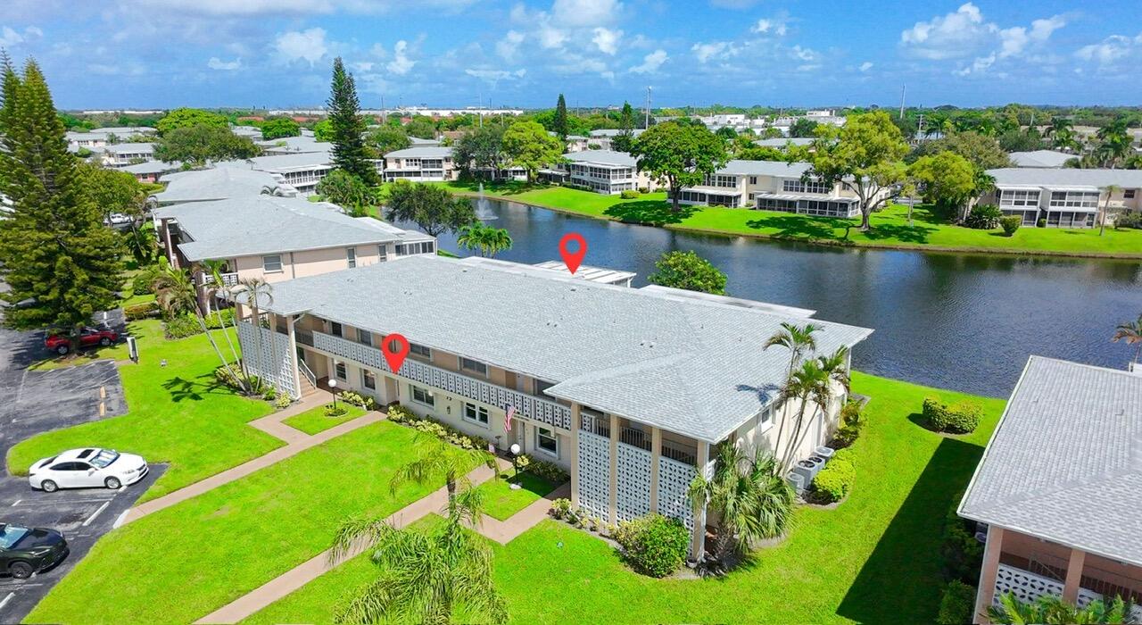 1421 Northwest 19th Terrace, Unit 102 Delray Beach, FL 33445 - Photo 25 of 31 an aerial view of a house with a garden and lake view