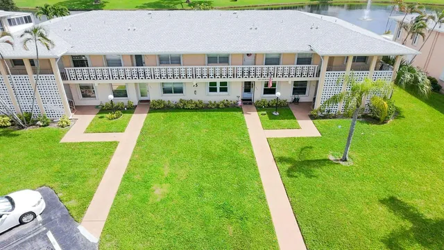 a view of house with a yard