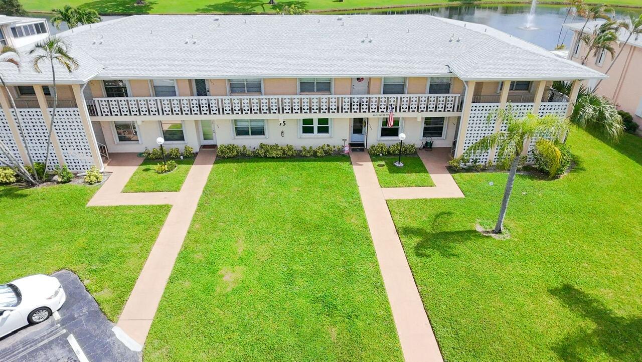 1421 Northwest 19th Terrace, Unit 102 Delray Beach, FL 33445 - Photo 26 of 31 a view of house with a yard