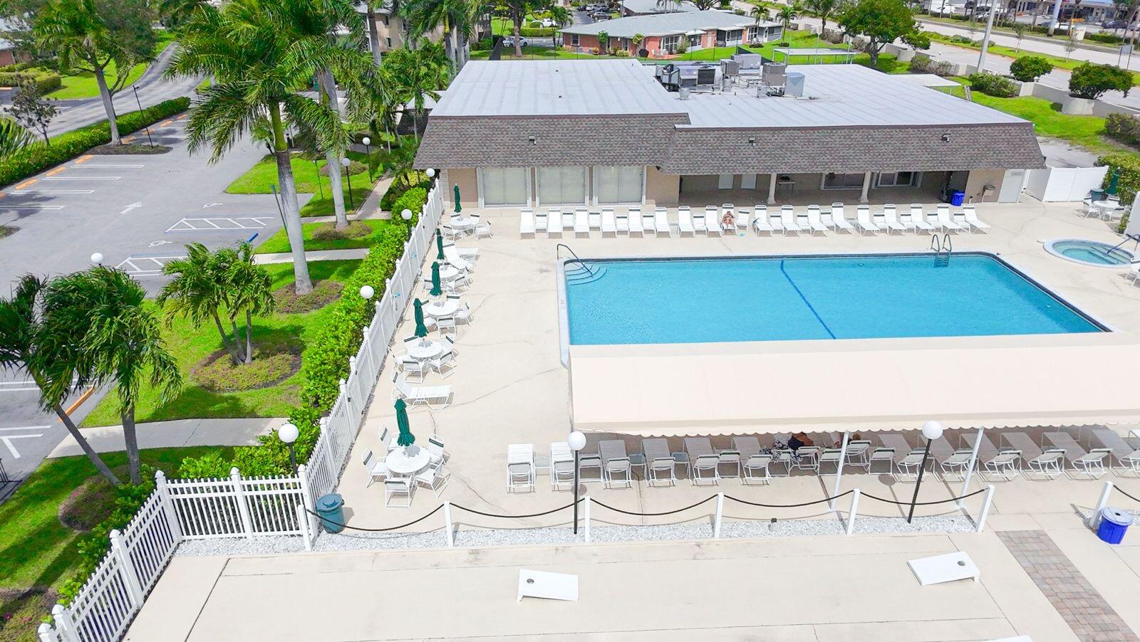 1421 Northwest 19th Terrace, Unit 102 Delray Beach, FL 33445 - Photo 29 of 31 a view of a patio with table and chairs potted plants