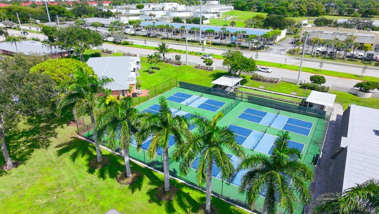 1421 Northwest 19th Terrace, Unit 102 Delray Beach, FL 33445 - Photo 31 of 31 a view of a swimming pool patio and lake view