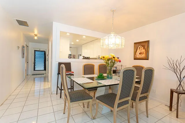a view of a dining room with furniture and chandelier