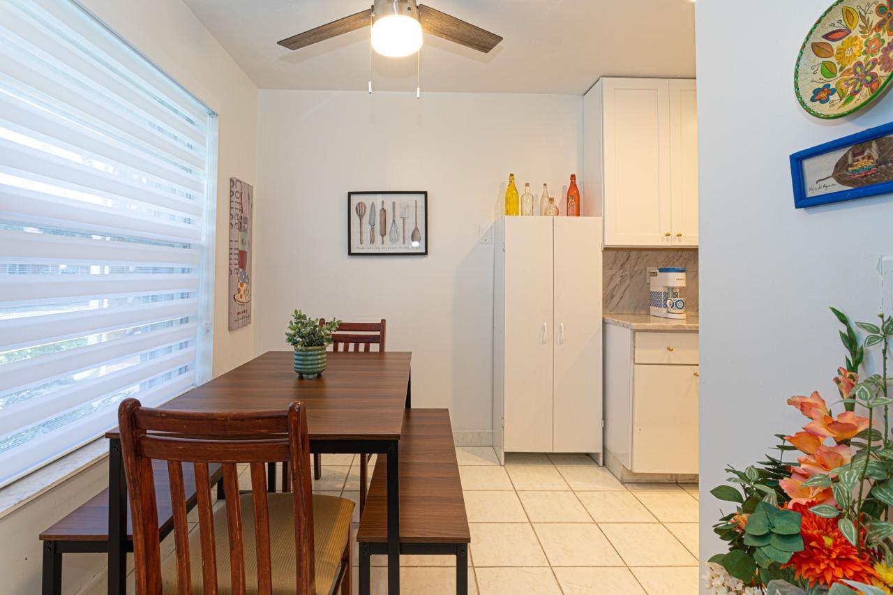1421 Northwest 19th Terrace, Unit 102 Delray Beach, FL 33445 - Photo 5 of 31 a view of a dining room with furniture