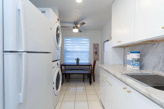 a kitchen with a refrigerator and a sink