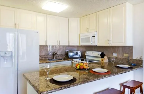 a kitchen with sink and view of counter top space