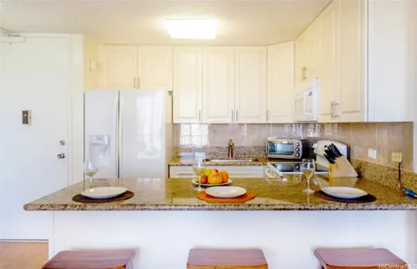 a kitchen with sink refrigerator and cabinets