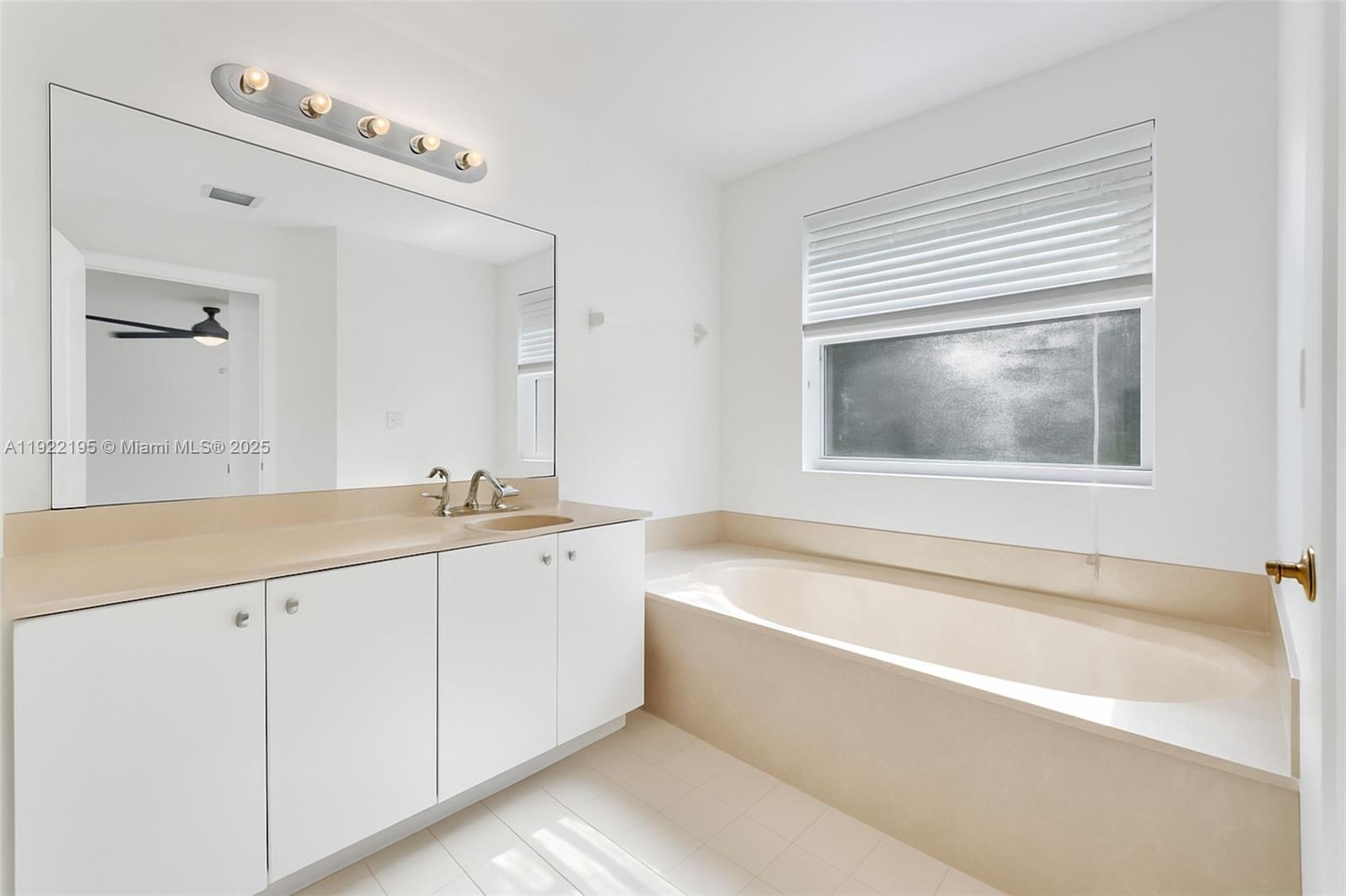 15854 Southwest 21st Street Miramar, FL 33027 - Photo 15 of 23 a bathroom with a tub a sink and mirror