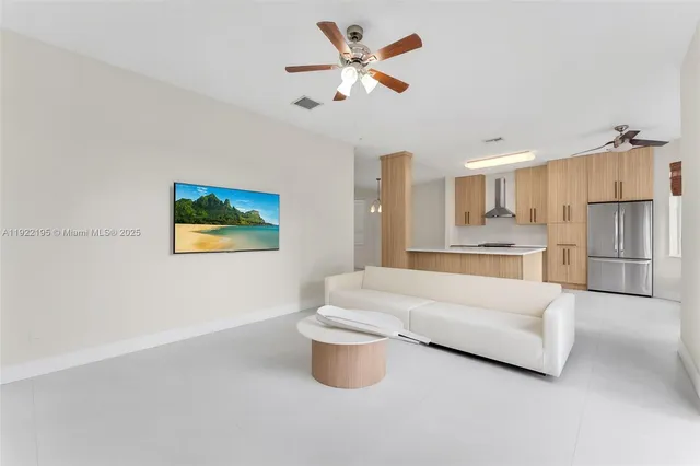 a spacious bedroom with a bed and a chandelier