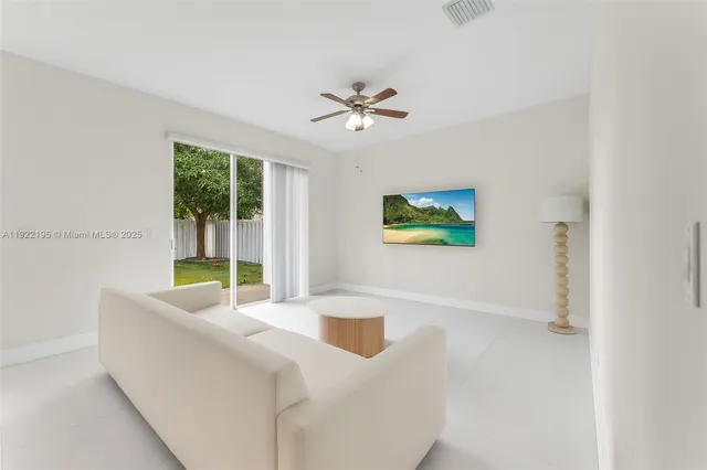 a living room with furniture and a ceiling fan