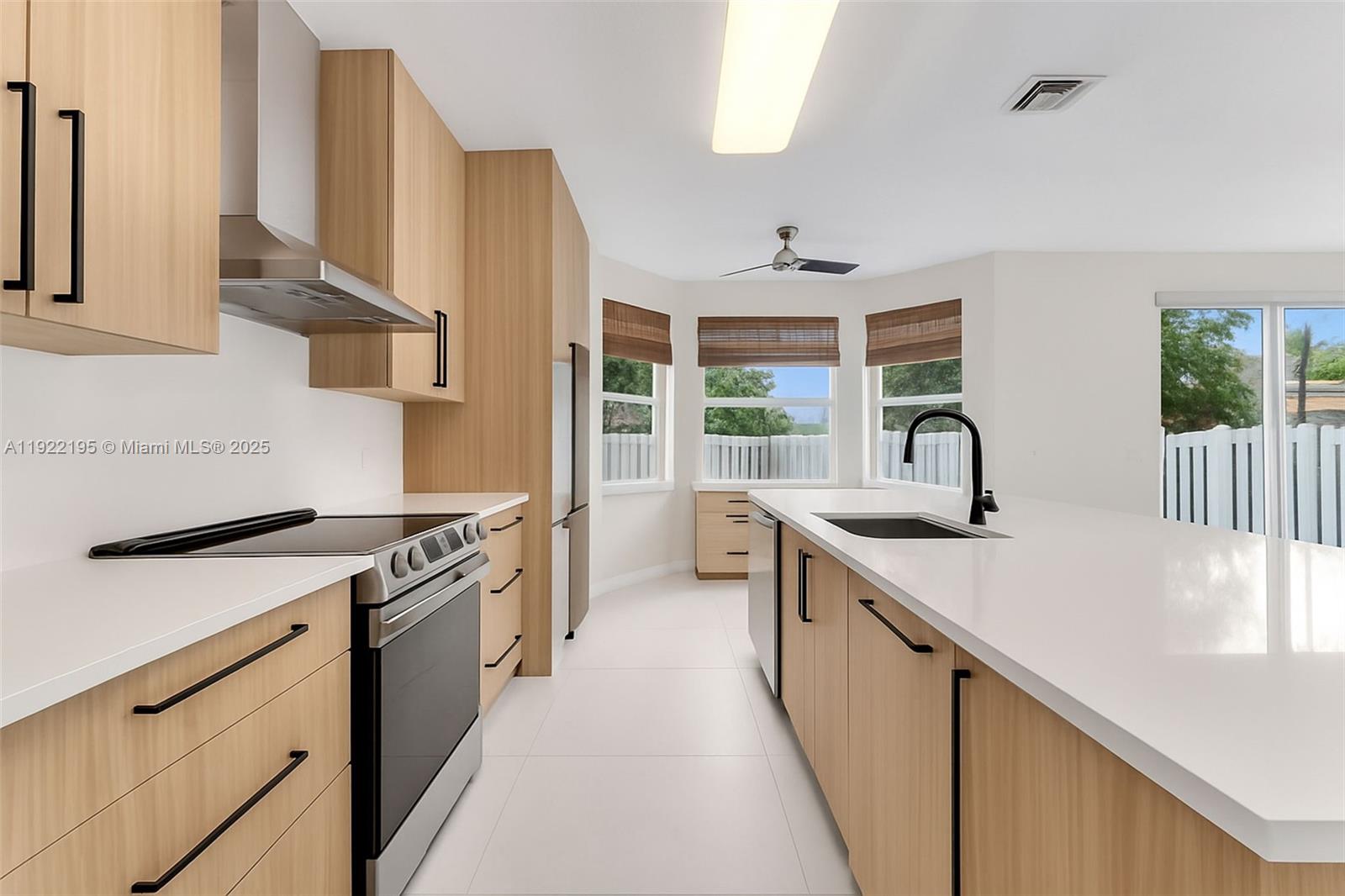 15854 Southwest 21st Street Miramar, FL 33027 - Photo 5 of 23 a kitchen with stainless steel appliances sink stove and cabinets