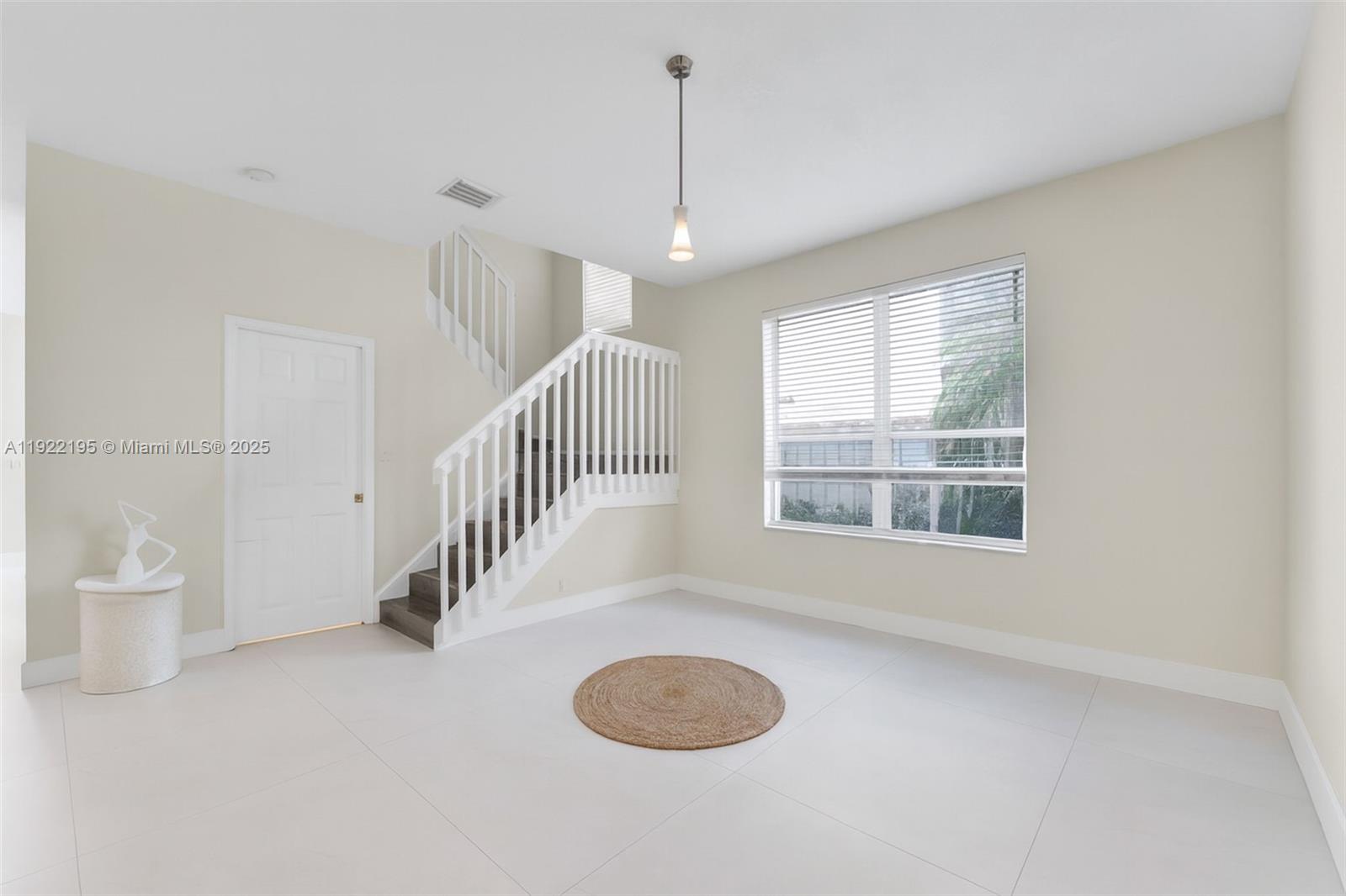 15854 Southwest 21st Street Miramar, FL 33027 - Photo 9 of 23 a view of an empty room with a window and wooden floor