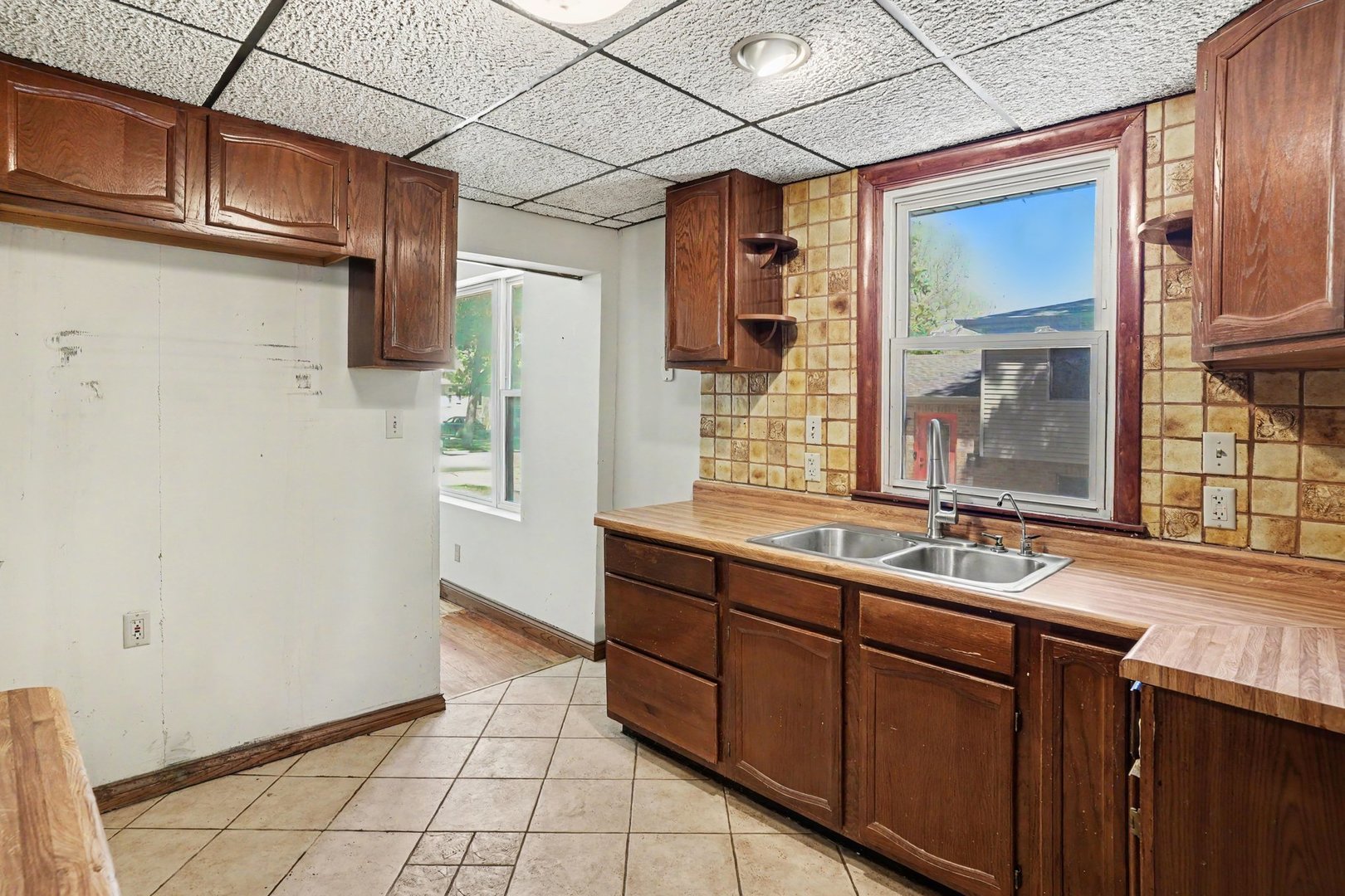 1661 Burr Oak Road Homewood, IL 60430 - Photo 8 of 17 a kitchen with a sink and a refrigerator