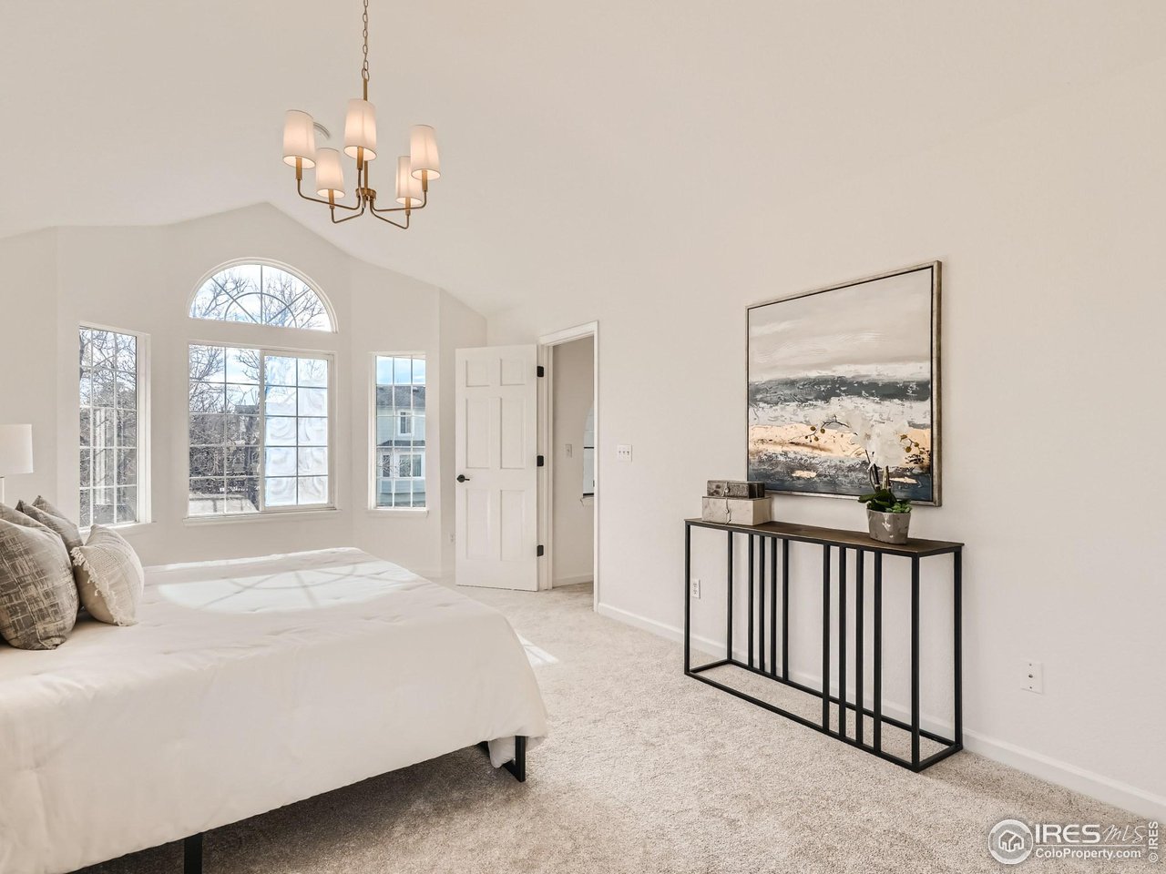 1285 Eldorado Drive Superior, CO 80027 - Photo 13 of 29 a spacious bedroom with a large bed and a chandelier