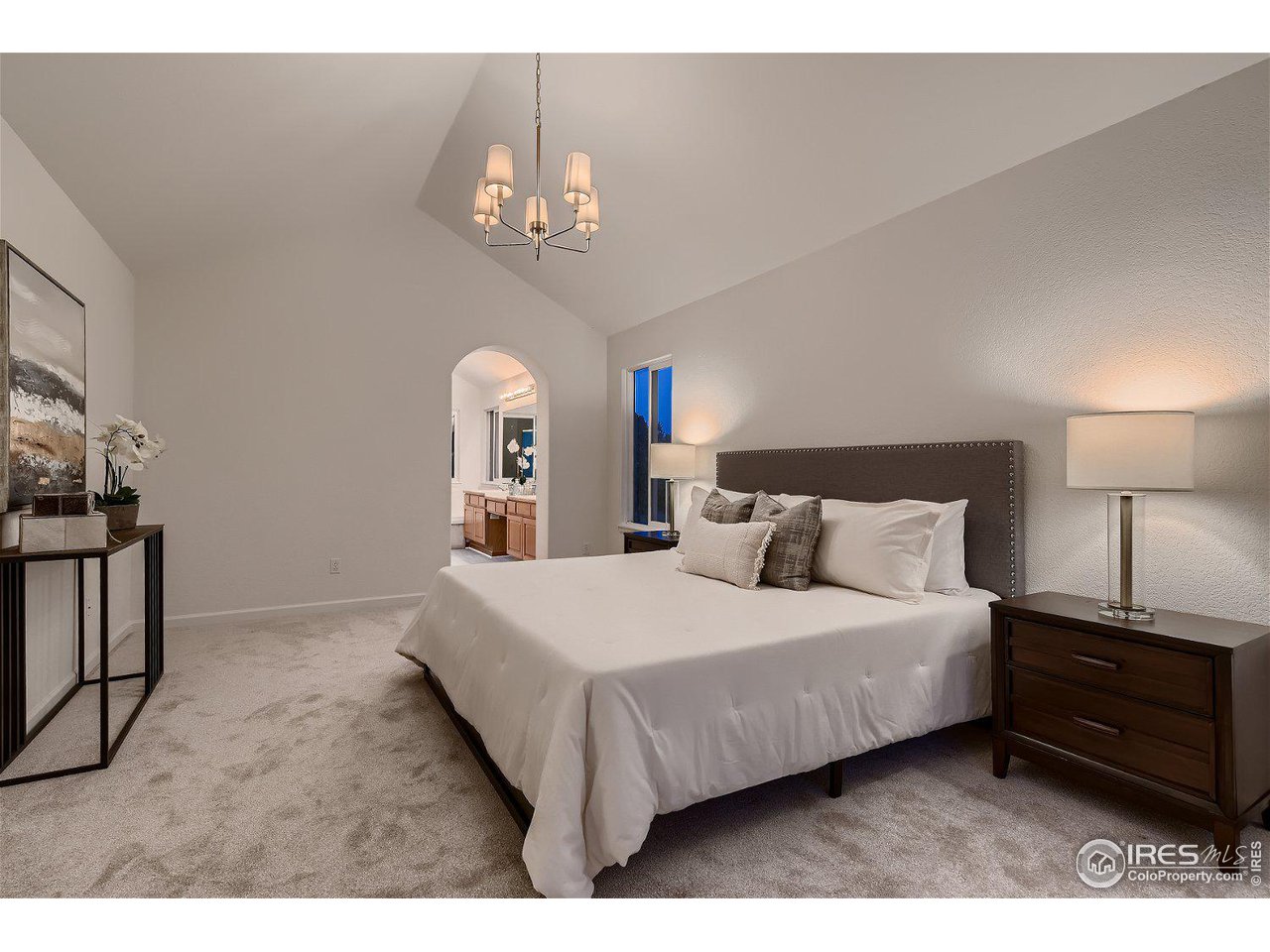 1285 Eldorado Drive Superior, CO 80027 - Photo 24 of 29 a bedroom with a bed a chandelier and dresser