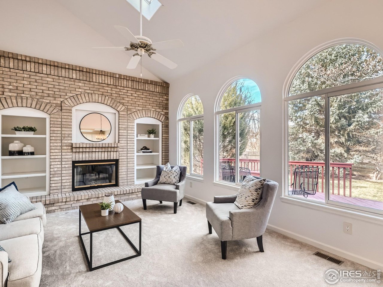 1285 Eldorado Drive Superior, CO 80027 - Photo 10 of 29 a living room with furniture a fireplace and a large window