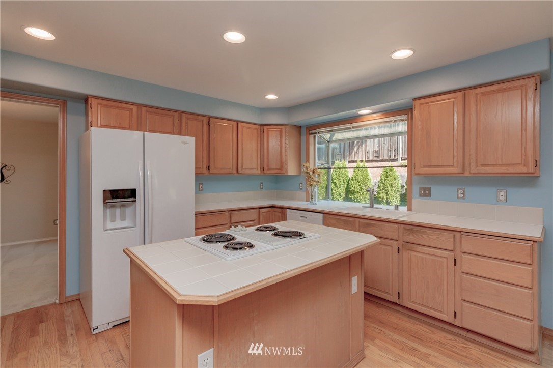 1822 Field Place Northeast Renton, WA 98059 - Photo 8 of 25 a kitchen with a sink a center island cabinets and appliances