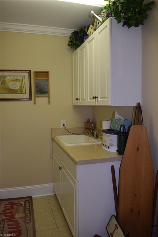 296 Canyon Road Mocksville, NC 27028 - Photo 20 of 30 Laundry room with sink cabinets and built in ironing board.