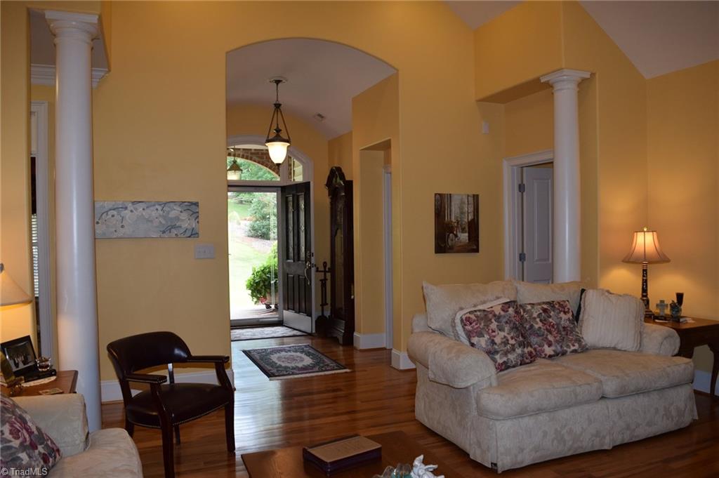 Living Room with arched ceilings, columns, and mouldings.