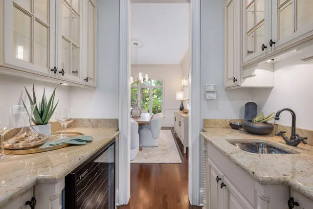 a kitchen with stainless steel appliances granite countertop a sink a stove and cabinets
