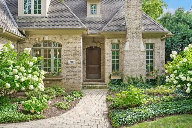 a front view of a house with a garden