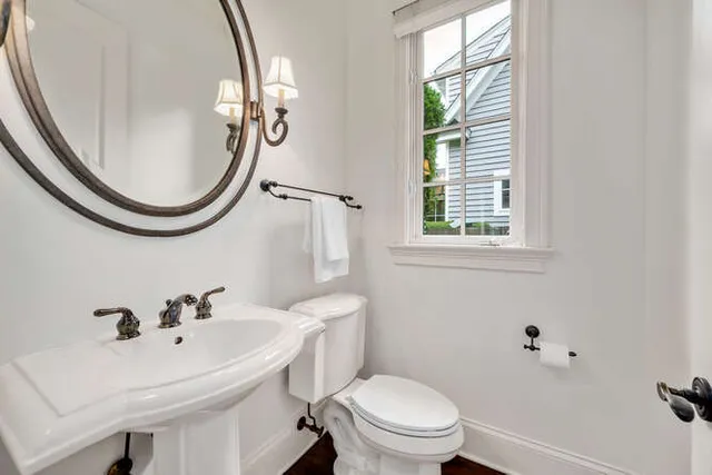 a bathroom with a sink a mirror and a toilet