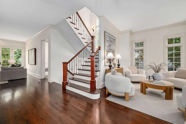a living room with furniture and a wooden floor
