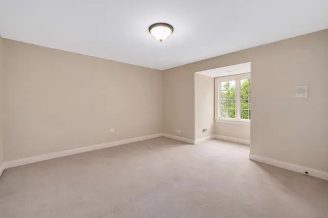 an empty room with a empty space and windows