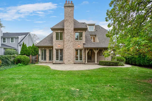 a front view of a house with a yard and trees