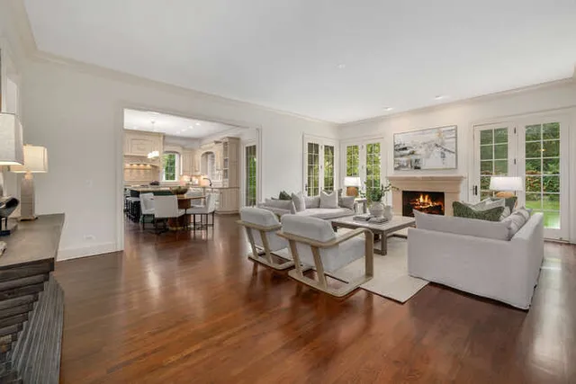 a living room with fireplace furniture and a wooden floor