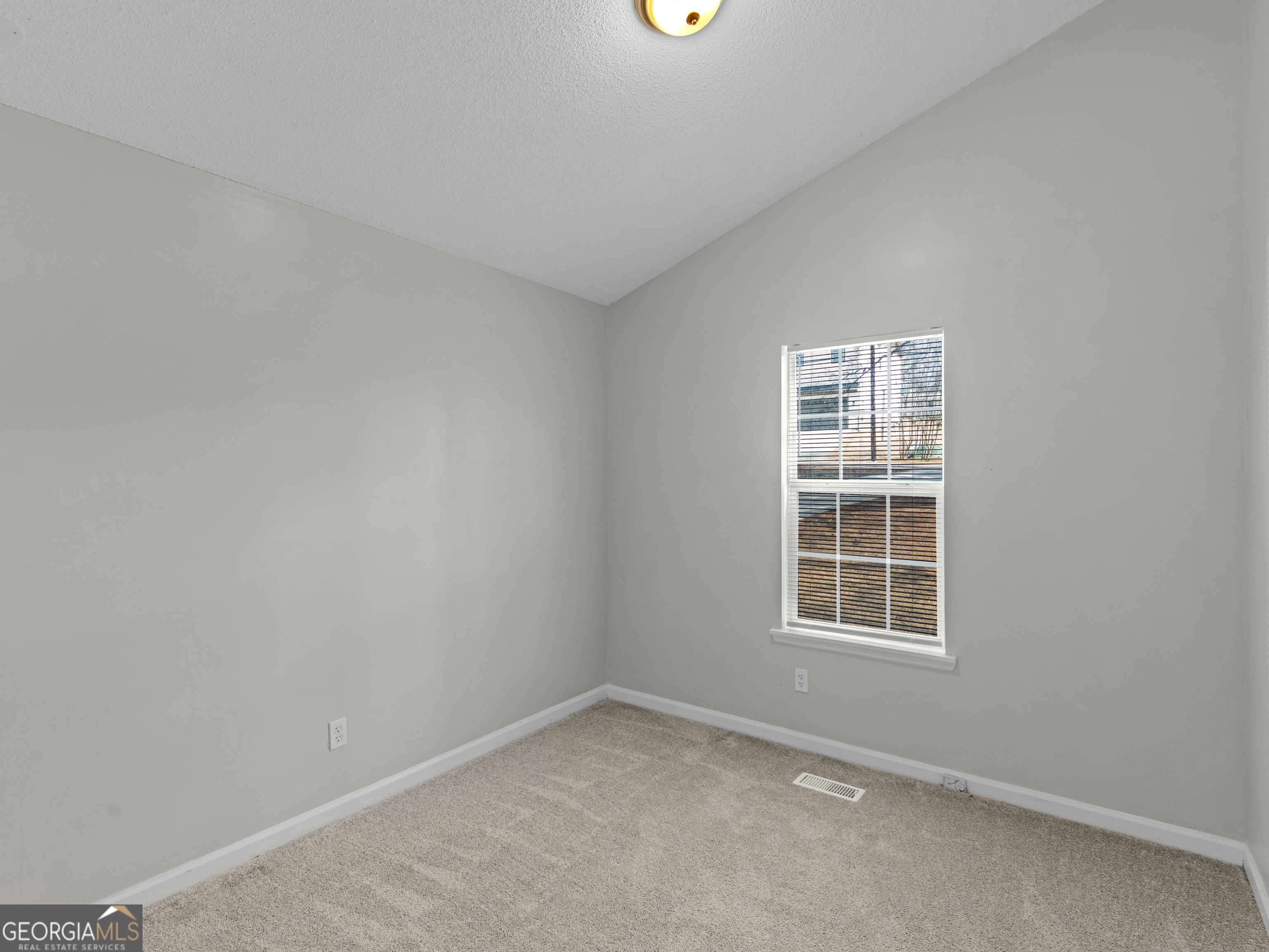 111 Neal Avenue Stockbridge, GA 30281 - Photo 15 of 27 an empty room with a window