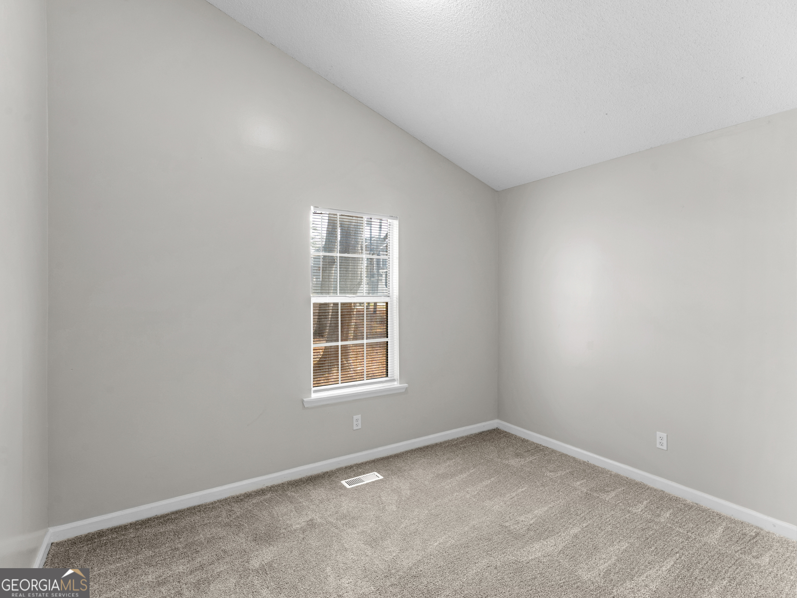 111 Neal Avenue Stockbridge, GA 30281 - Photo 18 of 27 an empty room with a window
