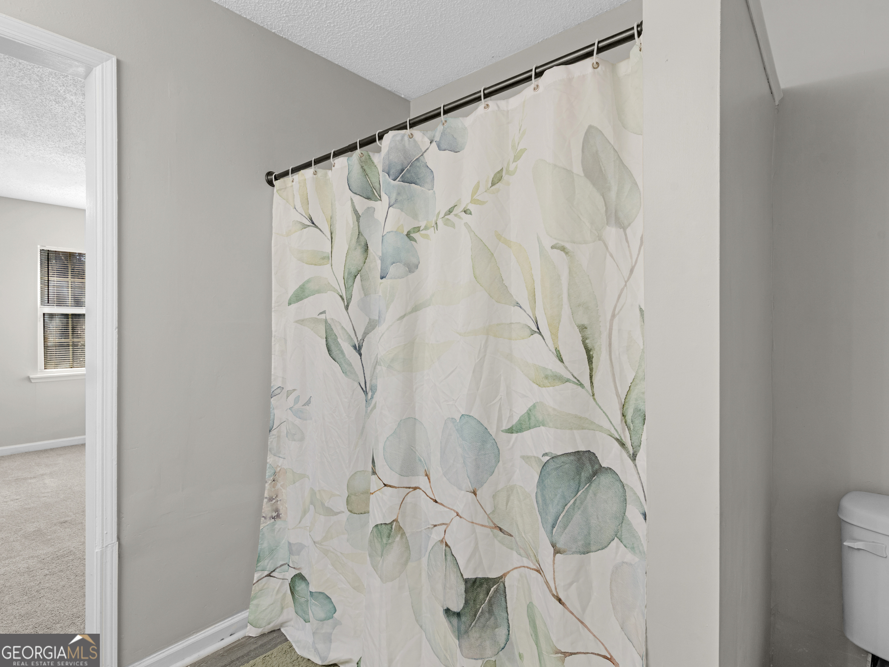 111 Neal Avenue Stockbridge, GA 30281 - Photo 22 of 27 a bathroom with a shower curtain and a shower curtain