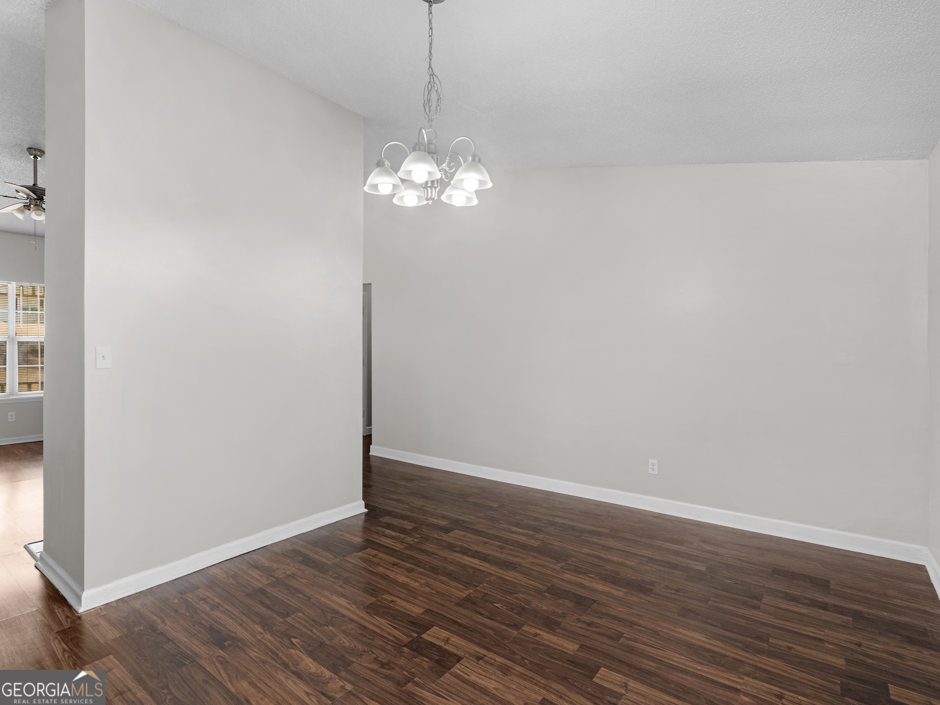 111 Neal Avenue Stockbridge, GA 30281 - Photo 5 of 27 a view of a chandelier fan and wooden floor