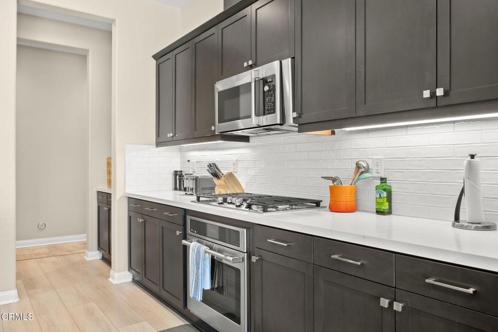 390 Rose Street Fillmore, CA 93015 - Photo 12 of 58 a kitchen with stainless steel appliances granite countertop a sink and a microwave