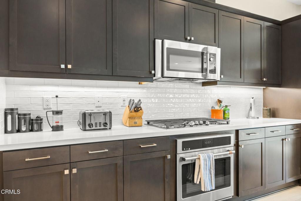 390 Rose Street Fillmore, CA 93015 - Photo 13 of 58 a kitchen with stainless steel appliances granite countertop a sink a stove and cabinets