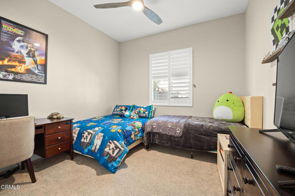 390 Rose Street Fillmore, CA 93015 - Photo 23 of 58 a bedroom with a bed and a desk