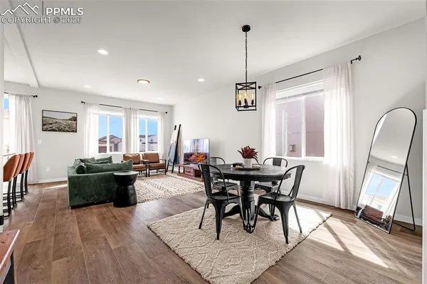 a view of a dining room with furniture window and wooden floor
