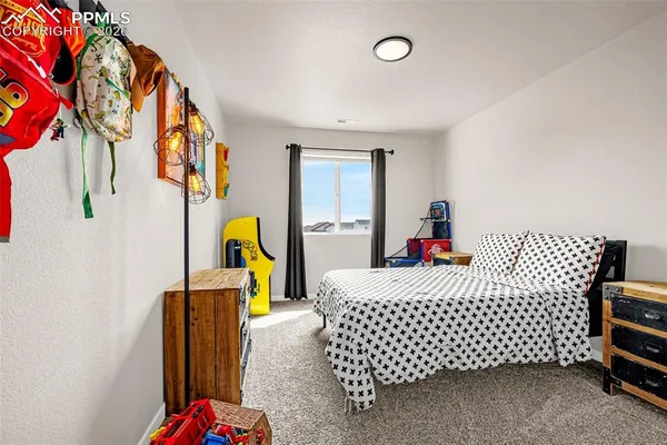 a bedroom with a bed and a painting on the wall