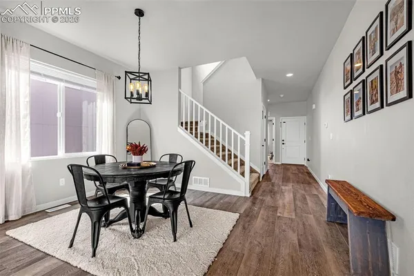 a view of a dining room with furniture window and wooden floor