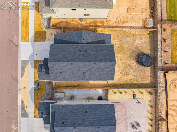 an aerial view of residential houses with outdoor space