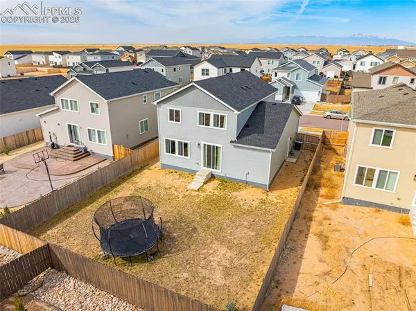 an aerial view of residential houses with outdoor space