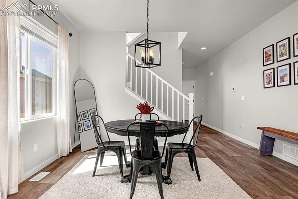 a view of a dining room with furniture and wooden floor