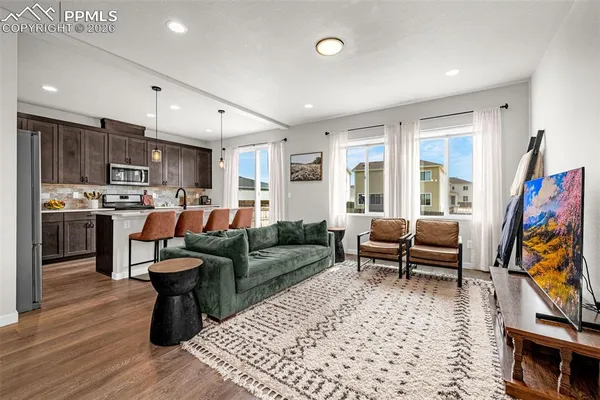 a living room with fireplace furniture and a flat screen tv