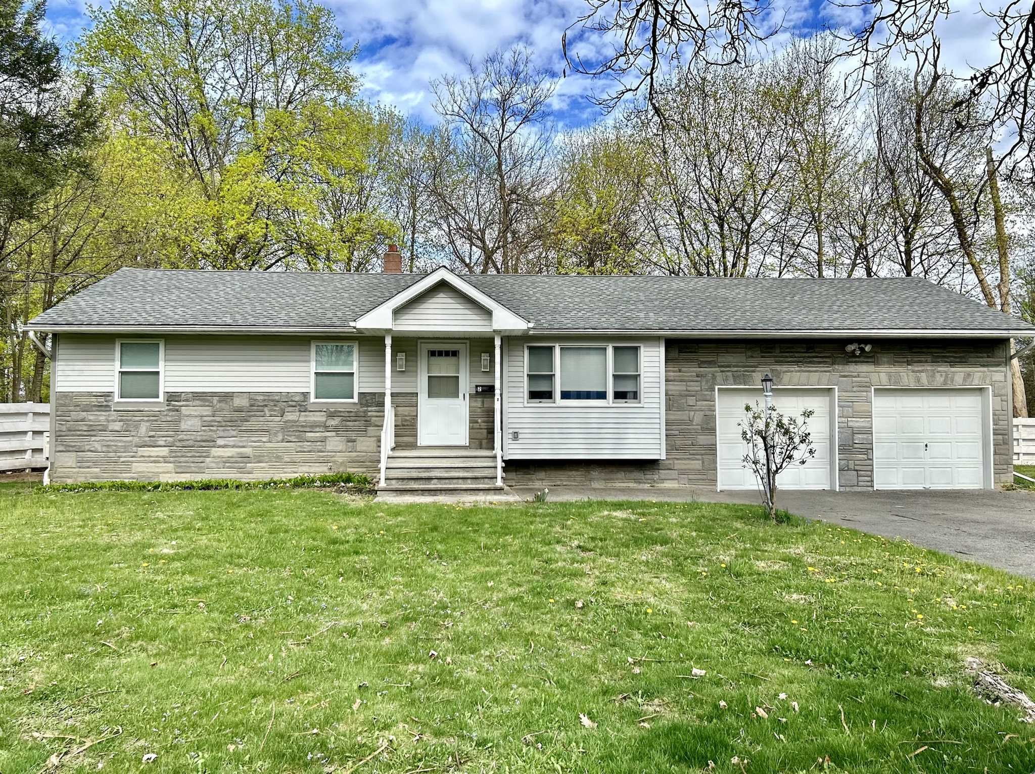 a front view of a house with a garden