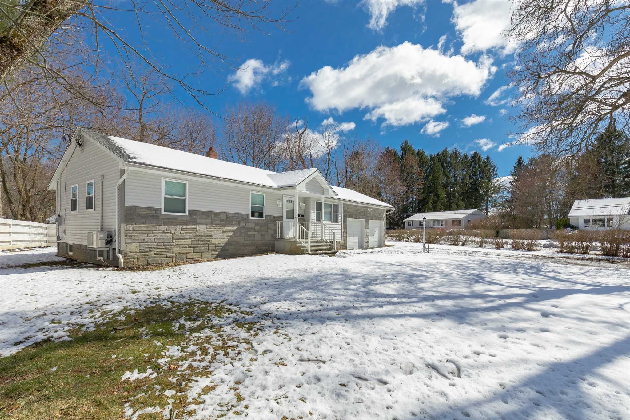 2 Cambridge Drive Red Hook, NY 12571 - Photo 14 of 17 a front view of a house with a yard covered with snow