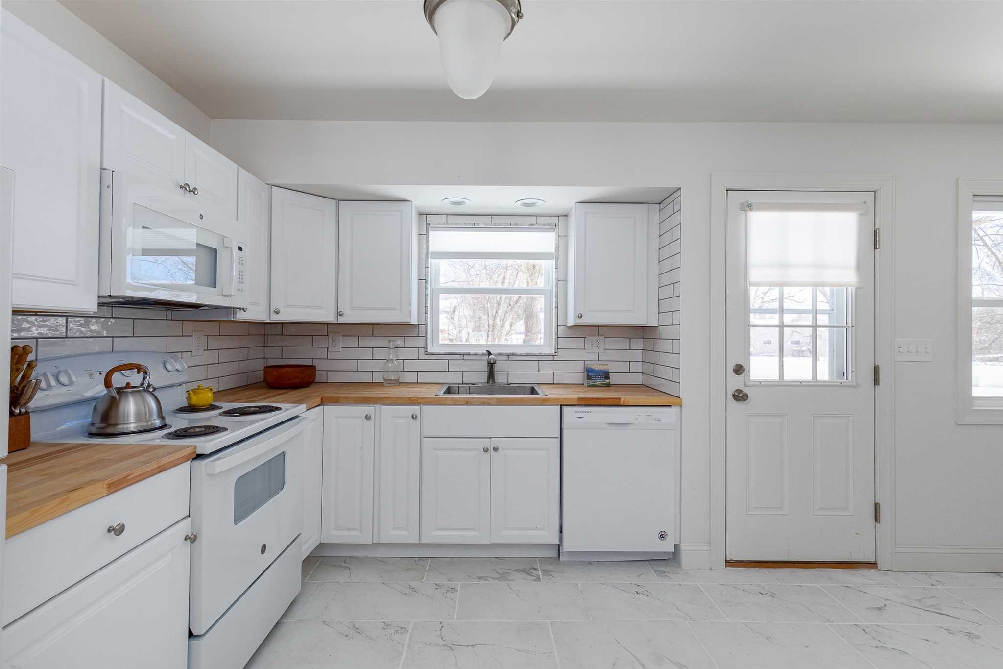 2 Cambridge Drive Red Hook, NY 12571 - Photo 5 of 17 a kitchen with white cabinets and white appliances