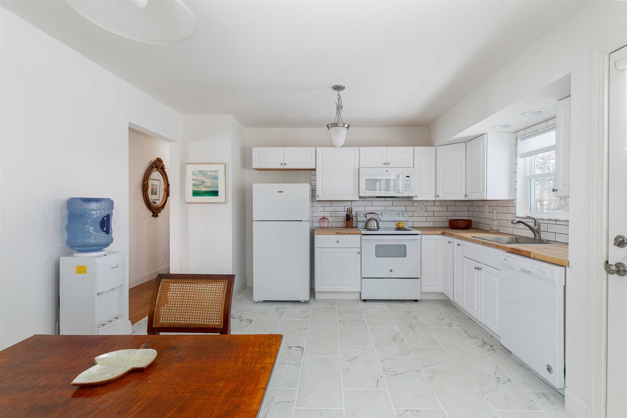 2 Cambridge Drive Red Hook, NY 12571 - Photo 7 of 17 a kitchen with white cabinets and refrigerator