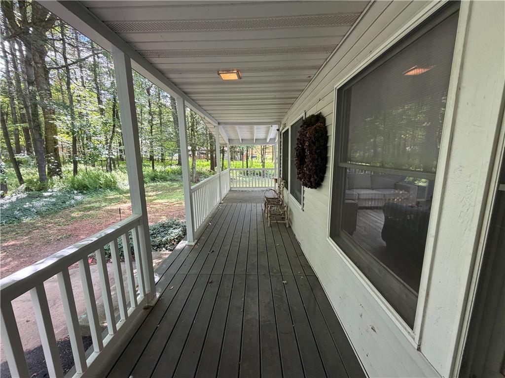 60 Sassafras Road Lehighton, PA 18235 - Photo 3 of 36 Embrace nature from this charming covered porch, offering tranquil woodland views.